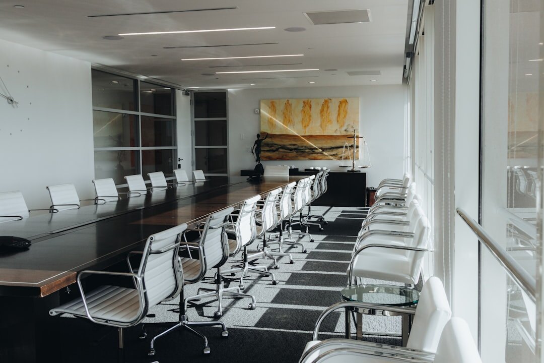 Empty modern meeting room with long table and city view